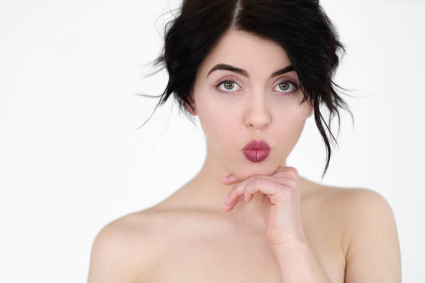 istock emotion face pin up pouting lips innocent woman 969994714