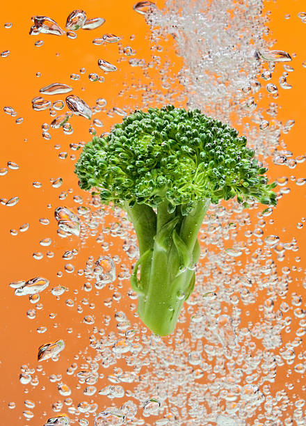 istock Green broccoli falling in water with air bubbles 96999794