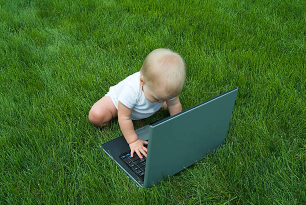 Baby Typing on Laptop stock photo