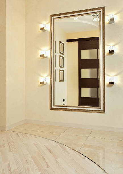 Beige modern anteroom with mirror in golden frame stock photo