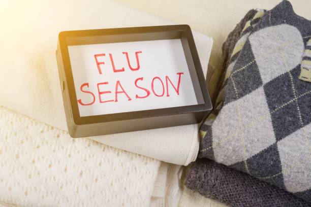 istock Flu season - text in frame. Background - warm woolen clothes 970023598