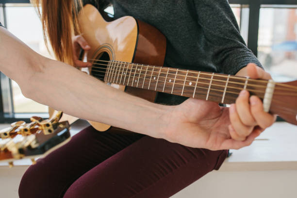 istock Learning to play the guitar. Music education and extracurricular lessons 970023738