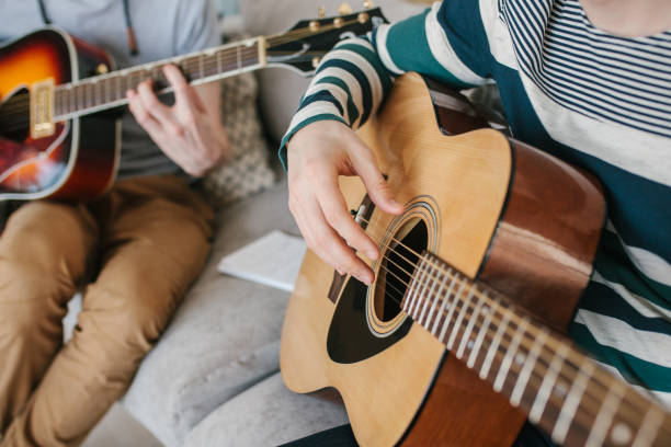 istock Learning to play the guitar. Music education. 970023856