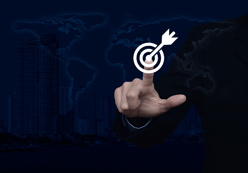 Businessman pressing target with dart icon over world map and modern city tower, Business success concept, Elements of this image furnished by NASA