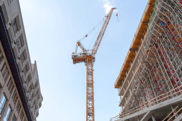 istock Construction site with crane, scaffold and office building, and a blue sky - Berlin 2018 970046776