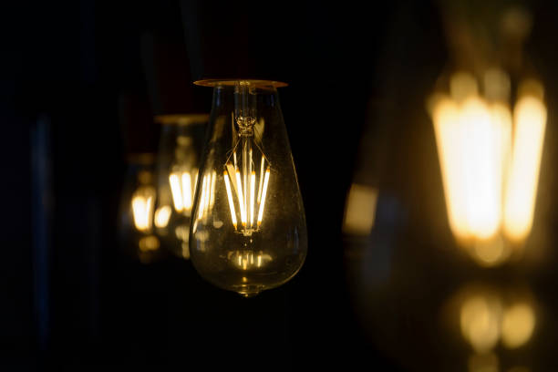istock Vintage light bulb close up, lighting bulb in the dark. 970047022