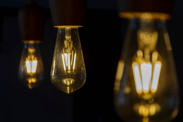 istock Vintage light bulb close up, lighting bulb in the dark. 970047034