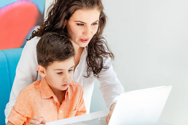 istock Mother and son looking at laptop together 970053066