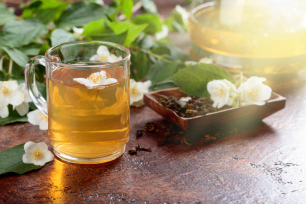 istock Green tea with jasmine in cup and teapot . 970056740