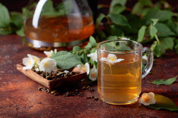 istock Green tea with jasmine in cup and teapot . 970056756
