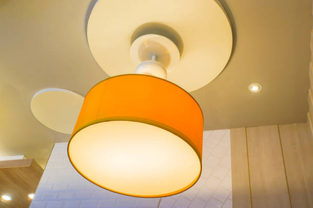 istock close up hanging orange glow creative design lamp on restaurant ceiling for decoration 970057136