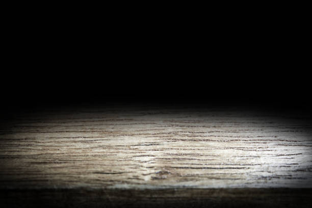 istock Wood table and black wall background, Empty wooden floor space platform with library background for product display. 970057796