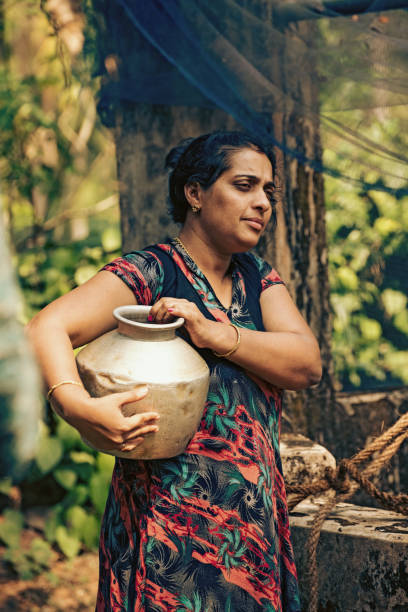 istock Indian woman fetching water from well 970060202