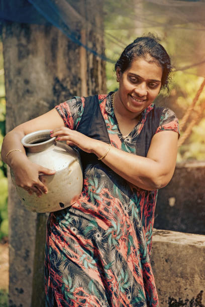 istock Indian woman fetching water from well 970060410