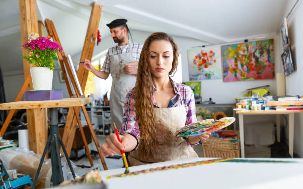 istock Fine art painters working in atelier together 970060602