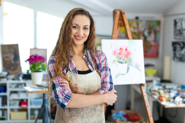 Woman painter posing in her studio
