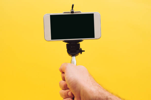 istock Hand and smartphone on selfie stick 970060928