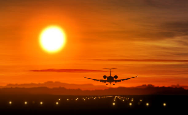 istock Airplane landing - private jet silhouette on sunset 970061288