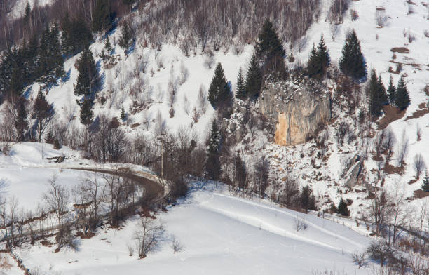 istock road in winter mountain landscape 970063852
