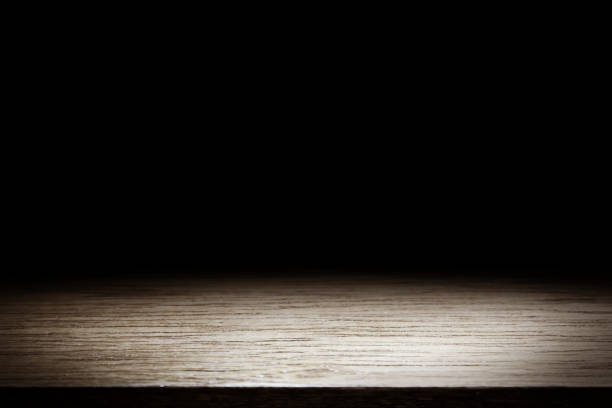 istock Wood table and black wall background, Empty wooden floor space platform with library background for product display. 970064080