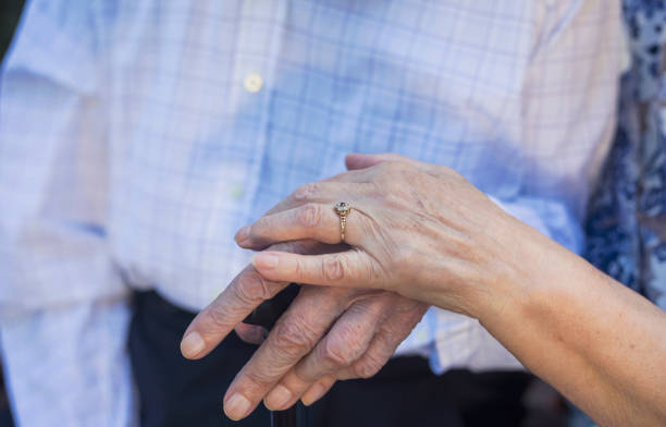 istock Elderly couple holding hands 970067096