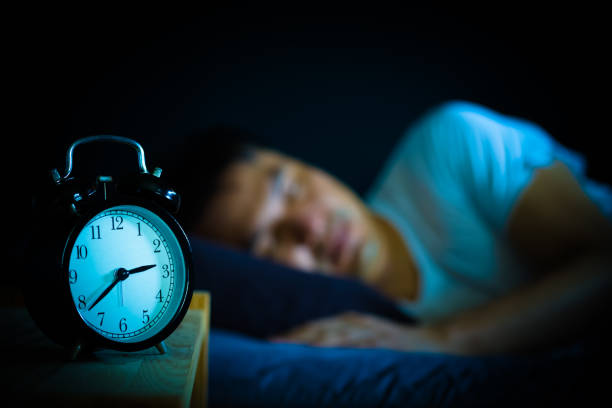 istock sleeping asian man in bed at night 970067216