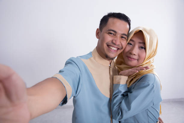 istock muslim couple taking selfie 970073654