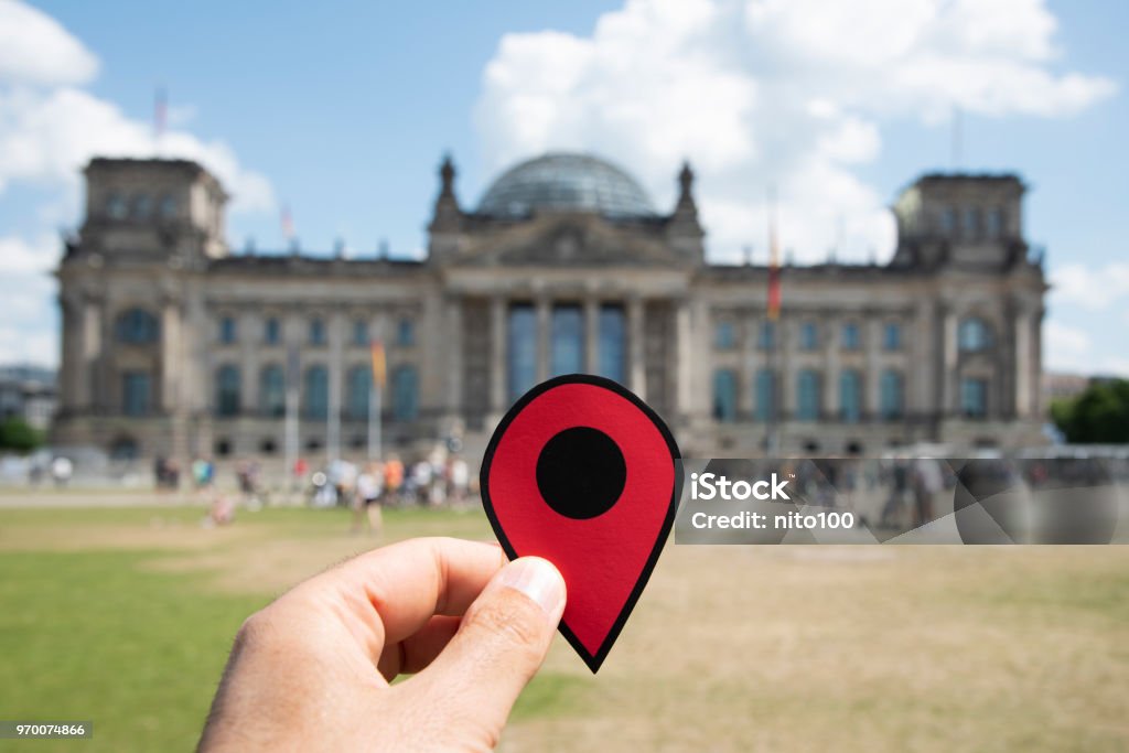 man with a red marker in front of the Reichstag closeup of the hand of a young caucasian man with a red marker in front of the Reichstag building in Berlin, Germany The Reichstag Stock Photo