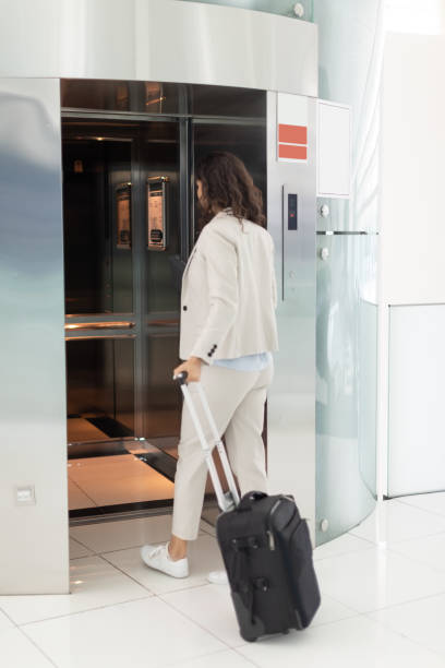 istock Businesswoman entering elevator 970078284