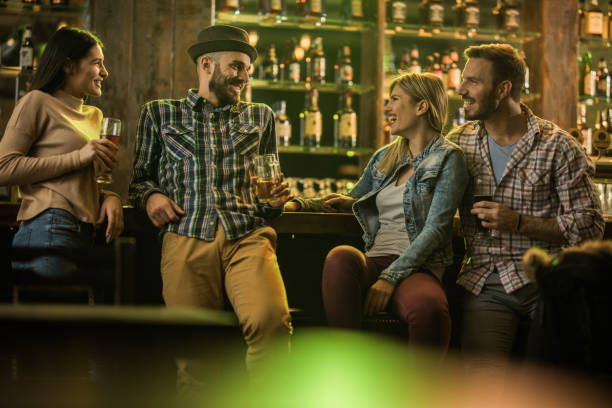 istock Young happy couples talking while enjoying in beer at a pub. 970078460