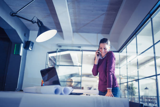 istock Young woman architect working late on a project 970085684