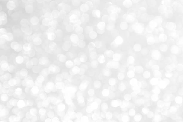 istock white blur abstract background. bokeh christmas blurred beautiful shiny Christmas lights 970090214