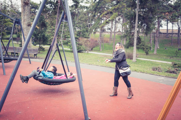Mixed race family, child siblings. Brother, sister and Caucasian mother, playing in the park