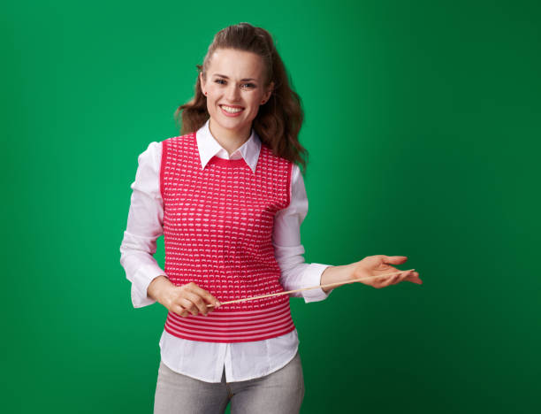 istock happy young student woman with pointer against green background 970091388