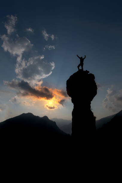 istock Climber rejoices after having conquered the summit with his hands up 970094910