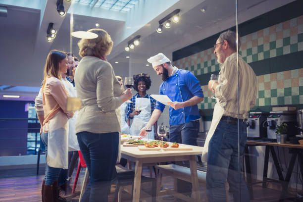 istock Chef is evalueting meals attendees of cooking class prepared. 970095970