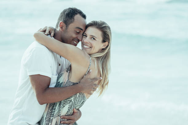 istock Loving Couple Embracing on Summer Beach 970096476