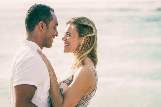 istock Middle-aged Couple Smiling and Embracing by Sea 970096670