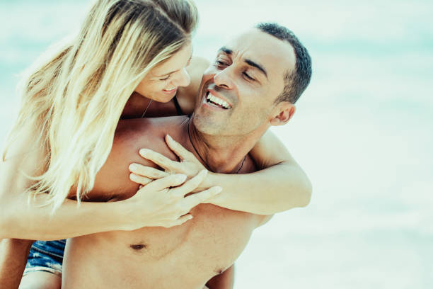 istock Smiling young man carrying his wife on shoulder 970097072