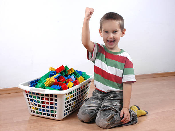 child cleaned the toy blocks stock photo