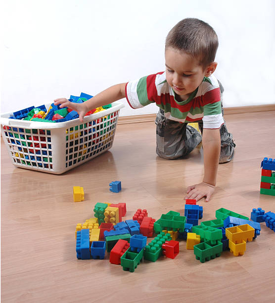 child collects the toy blocks stock photo