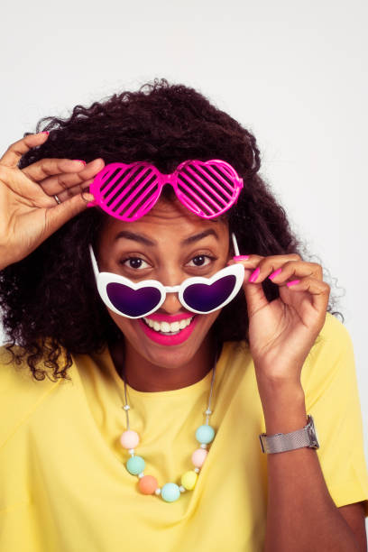 istock Woman playful using heart-shaped sunglasses. 970101010
