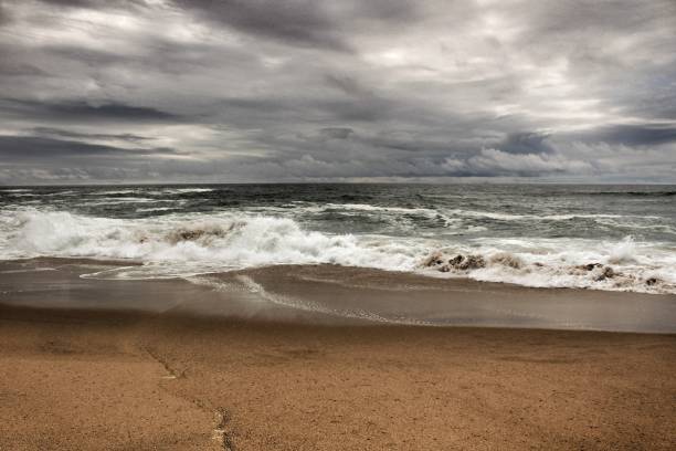 istock Brave ocean, rock formations and cloudy drama sky on the beach 970105398