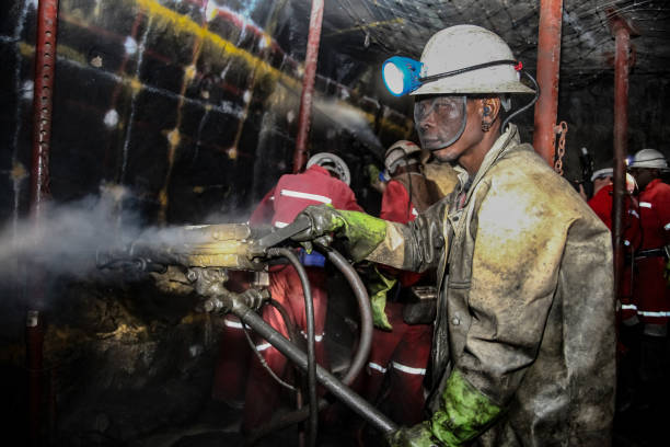Underground Platinum Chrome miners drilling blast holes Rustenburg, South Africa, May 23, 2011, Underground Platinum Chrome miners drilling holes in rock for blasting. Holes used for dynamite placement platinum photos stock pictures, royalty-free photos & images