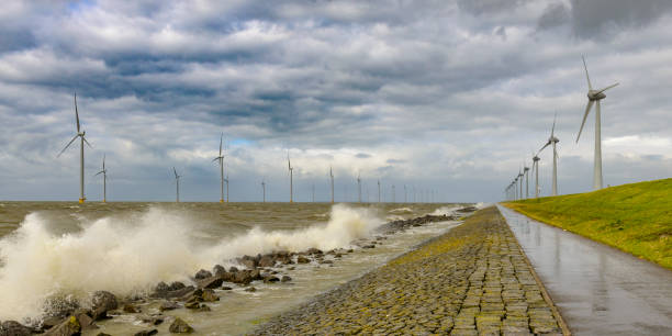 istock Wind turbines on land and offshore in a storm 970108694