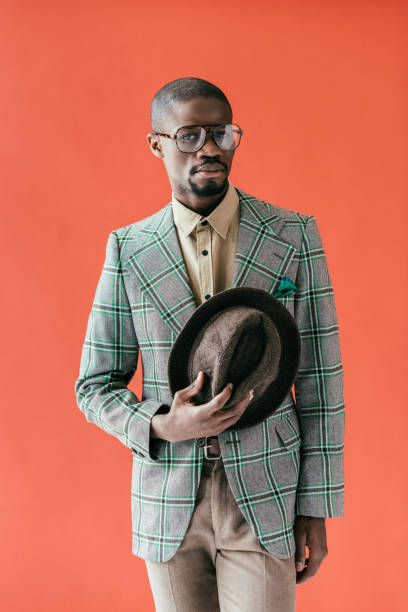 istock handsome african american man with vintage hat, isolated on red 970109822