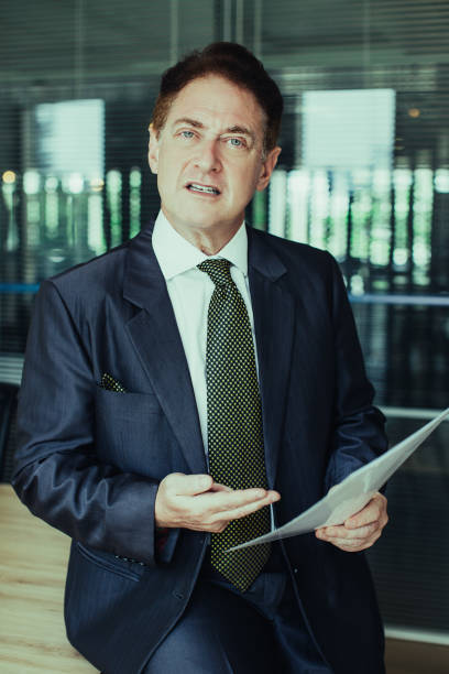 istock Displeased senior businessman pointing at document 970110254