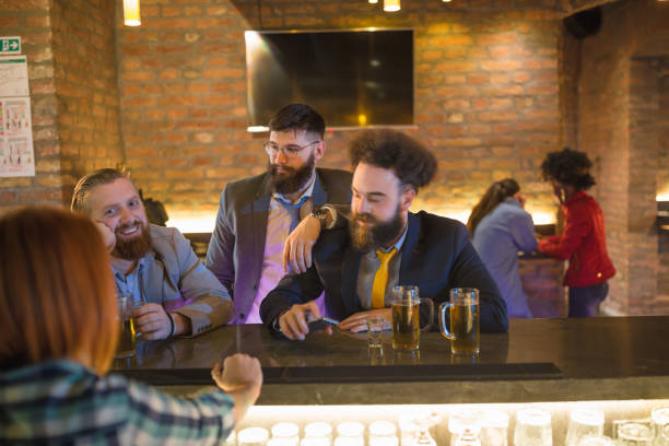 istock Three businessman having fun after work, sitting on the bar counter 970110272