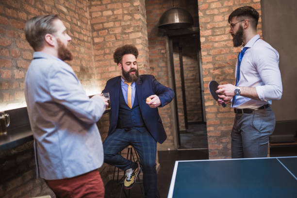 istock Group of young businessman playing table tennis after work 970117280