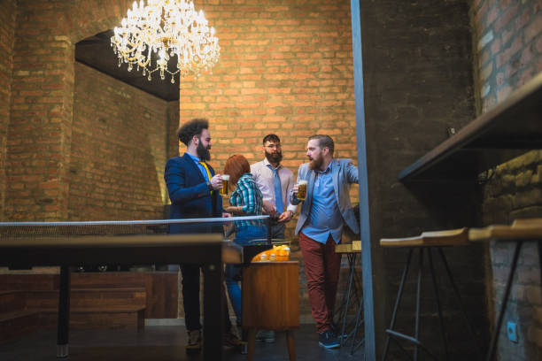 istock Group of young businessman playing table tennis after work 970117314